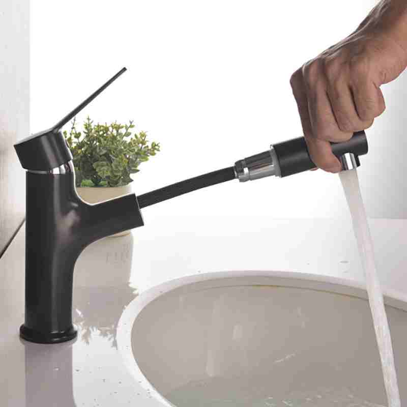 Full copper black circular pull-out faucet on the washbasin countertop in the bathroom